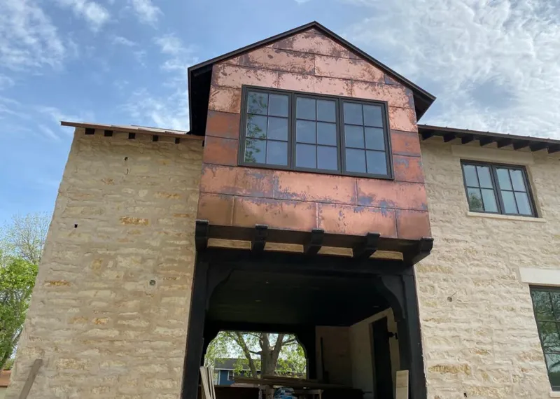 Copper metal panel facade on a stone building for Skylight Installation in Huntingburg